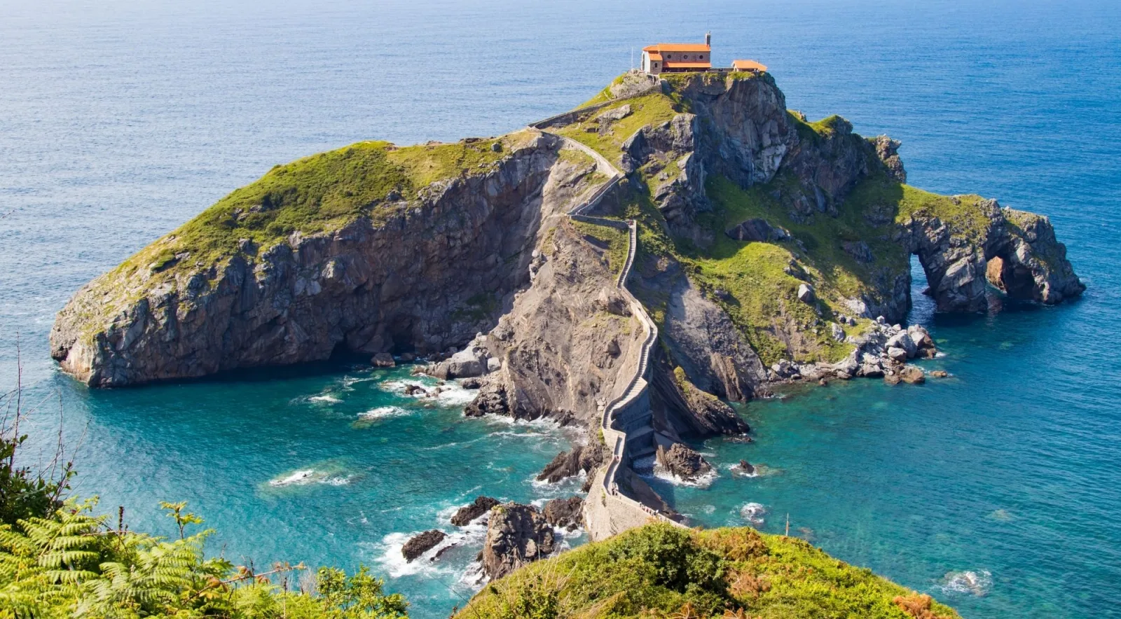 Aerial view of San Juan de Gaztelugatxe, its hermitage and the zigzag stone causeway linking the islet to the Biscay coast